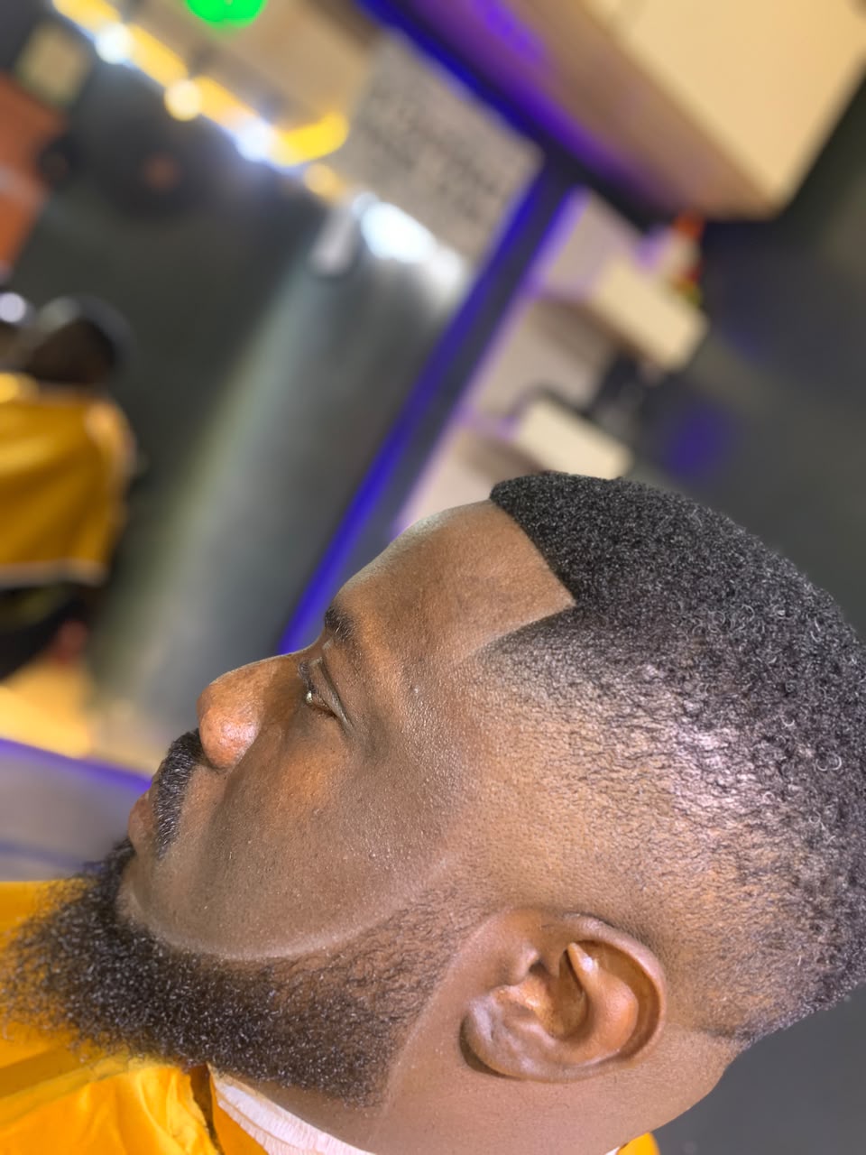 Close-up of a sharp fade and defined beard line